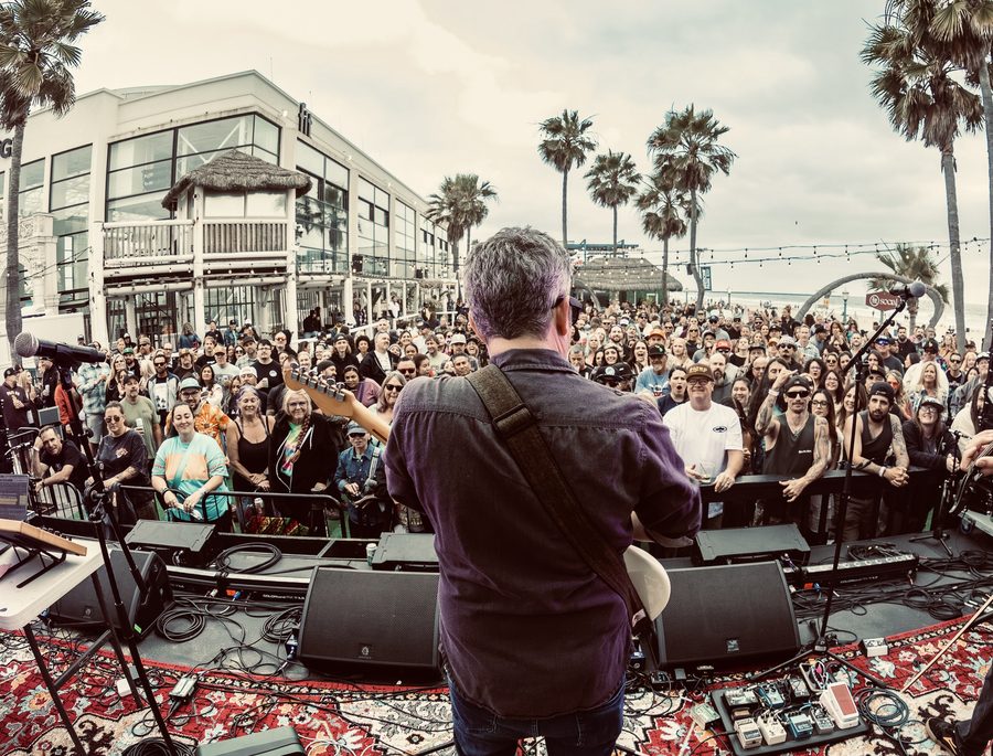 Performer seen from behind facing a packed crowd