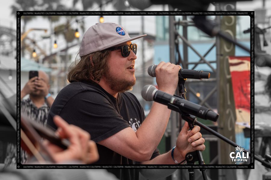 Vocalist in cap and sunglasses at the microphone