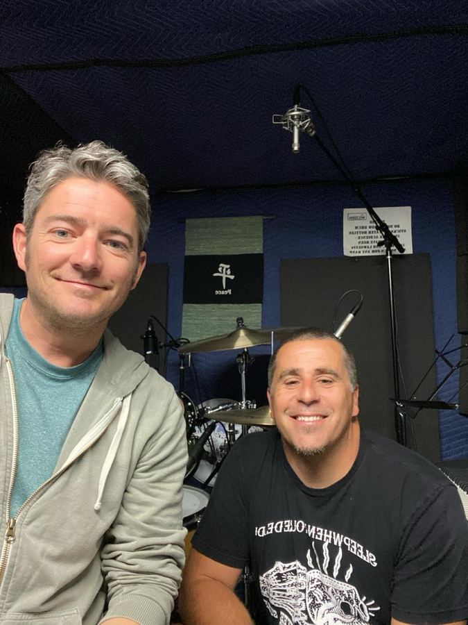 Alific and a friend in the studio in front of the drum kit